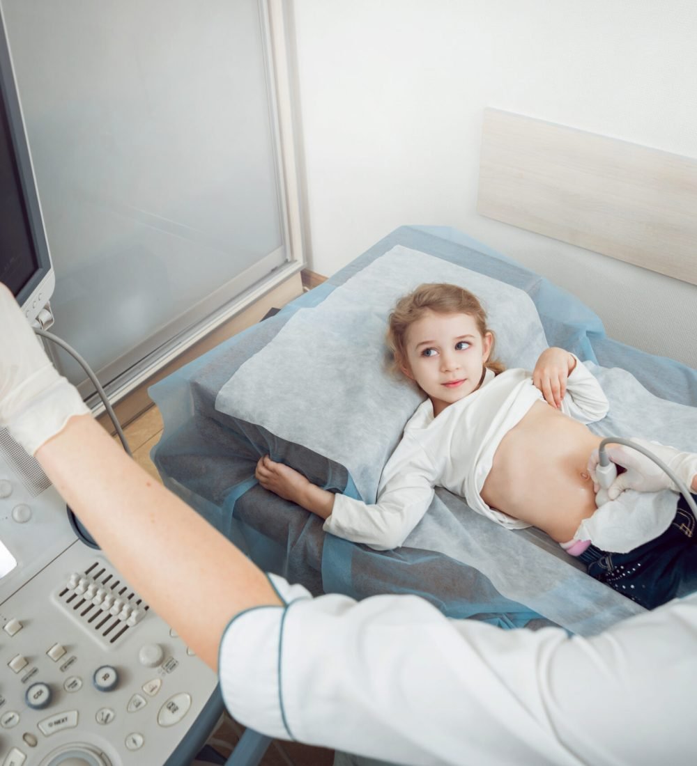 Doctor and little girl patient. Ultrasound equipment. Diagnostic and Sonography.
